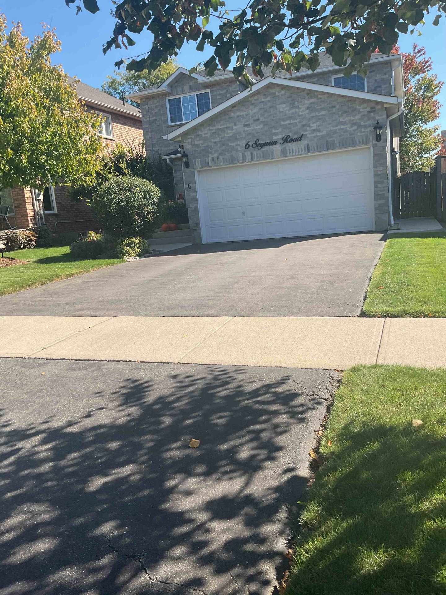 Faded asphalt driveway in Hamilton before professional sealing by Pro Seel